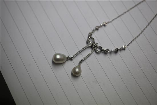 A Belle Epoque white metal natural saltwater pearl and diamond set double drop pendant necklace, 42cm.